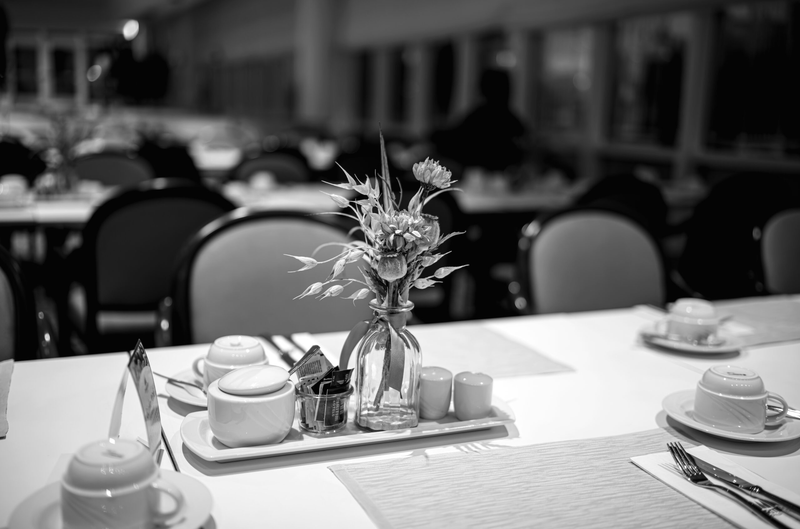 A table with a vase of flowers on top of it